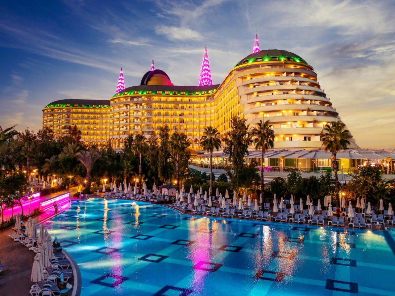 Delphin Imperial Lara beleuchtetes Hotel mit Pool bei Abenddämmerung